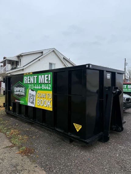 Empire Dumpsters roll-off dumpster on a Metro Detroit home driveway